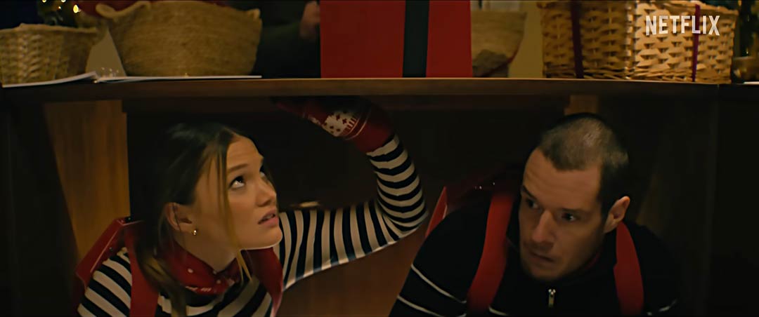 Red futuristic hard shell backpack featured in Jingle Bell Heist heist scene